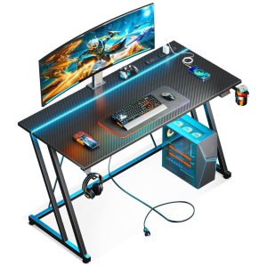 Mesa Gamer 47" 119 cm com Textura de Fibra de Carbono Gancho para Fone de Ouvido Tomadas 1 Portas USB e Luz LED 110V MOTPK Preto
